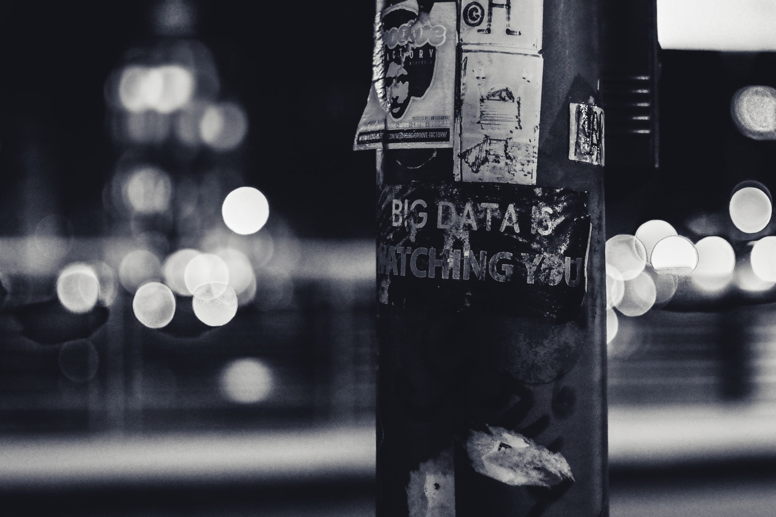A lamppost with a sticker on it. The sticker states 'big data is watching you'.