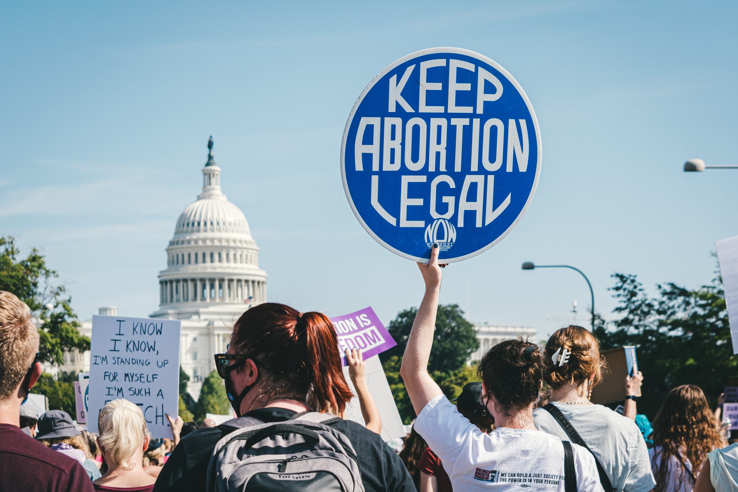 US anti-abortion protest with a protestor holding a 'keep abortion legal' sign aloft